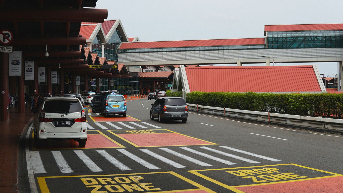 a city street with cars parked on the side of the road